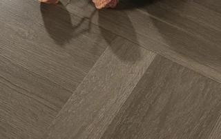 Dark brown parquet LVT flooring installed in a square wood-grain pattern